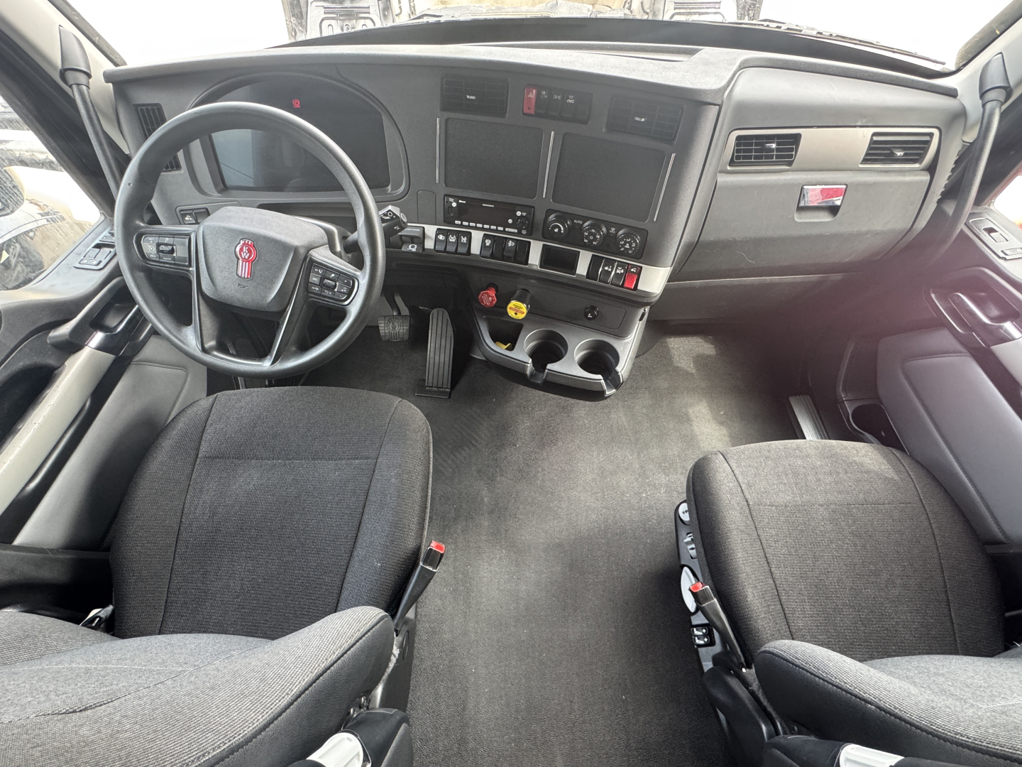Kenworth T680 truck interior/dashboard view with steering wheel and center console