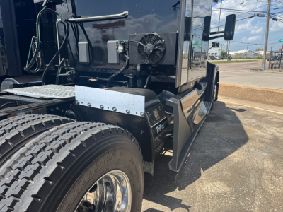 Kenworth T680 truck chassis and sleeper cab side view showing rear dual wheels, fuel lines, and side step with metallic guard.