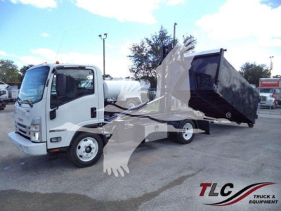 Isuzu NPR HD truck with a large tilting dump/dump body and hooklift setup, side view showing cab and front of vehicle.