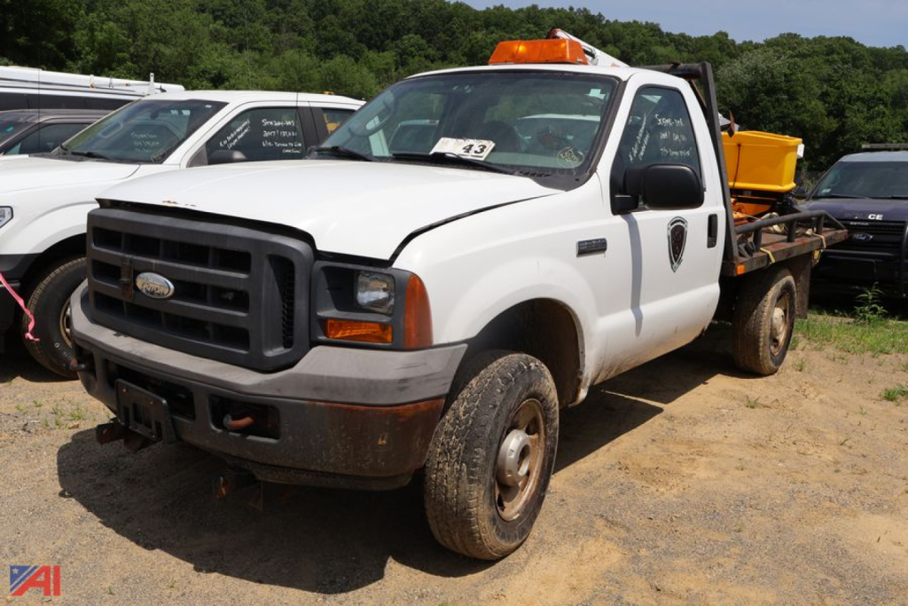 Ford F-250 Super Duty pickup with plow and salter, white, front-left view, utility body, 4x4, used vehicle.