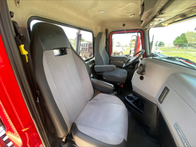 Mack AN64T truck cab interior showing driver and passenger seats with steering wheel and dashboard in view.