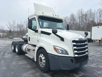 Truck cab and chassis showing Freightliner Cascadia 126 daycab with white exterior and large chrome grille.