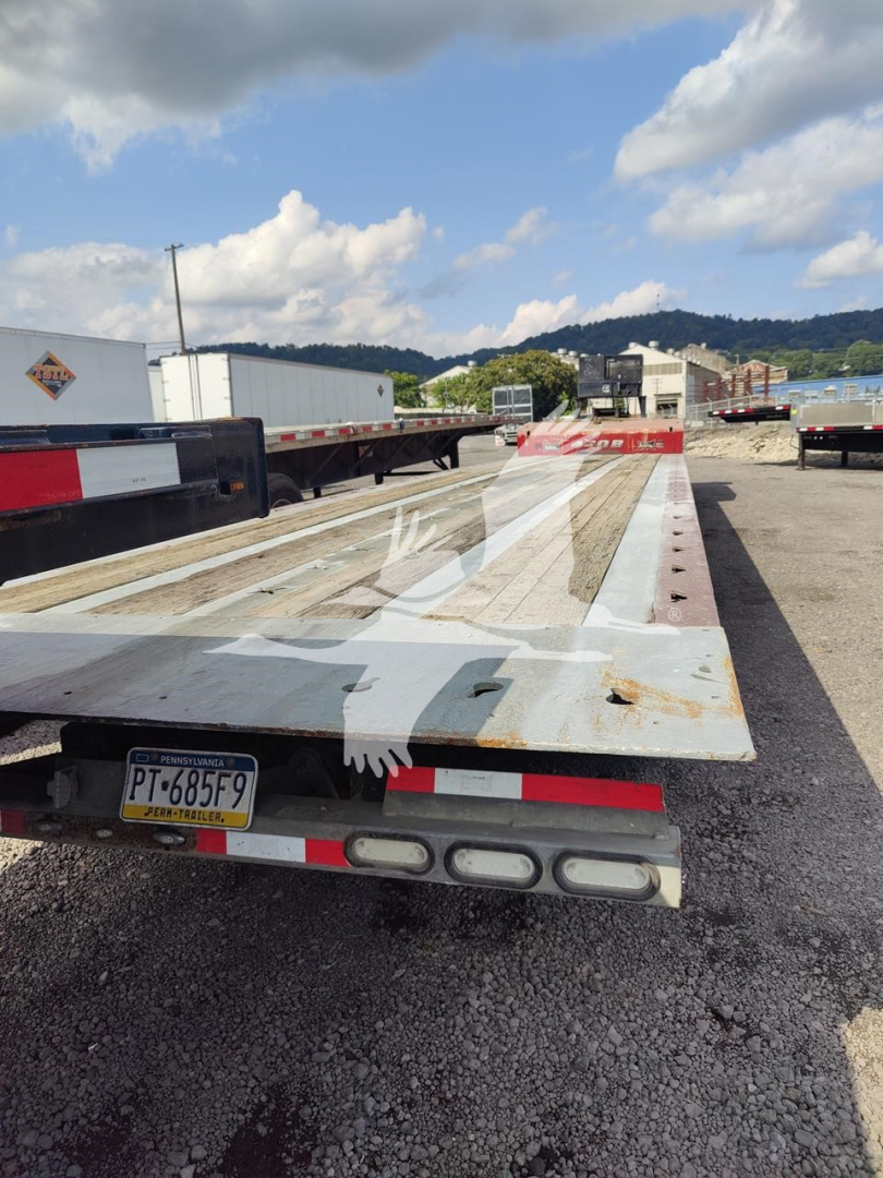 2019 Landoll 440B trailer deck and rear light assembly showing rugged wooden deck with white painted surface and license plate PT-685F9.