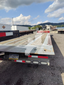 2019 Landoll 440B trailer deck and rear light assembly showing rugged wooden deck with white painted surface and license plate PT-685F9.