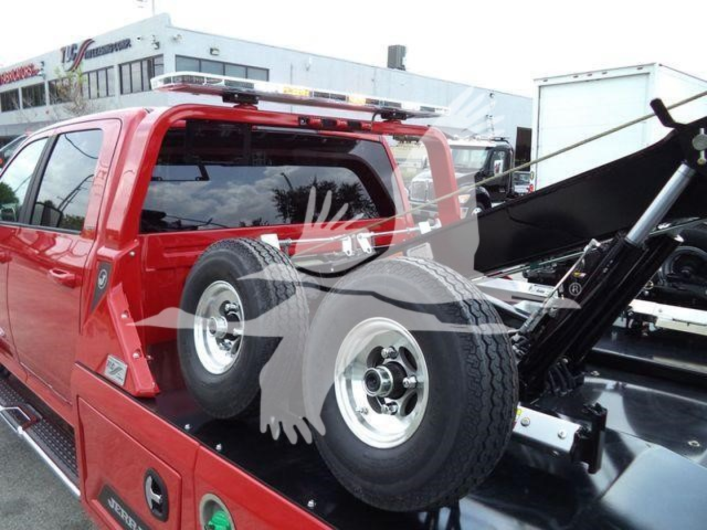 Ram 5500 Laramie pickup bed with spare tire mounted on back and winch equipment visible in bed.