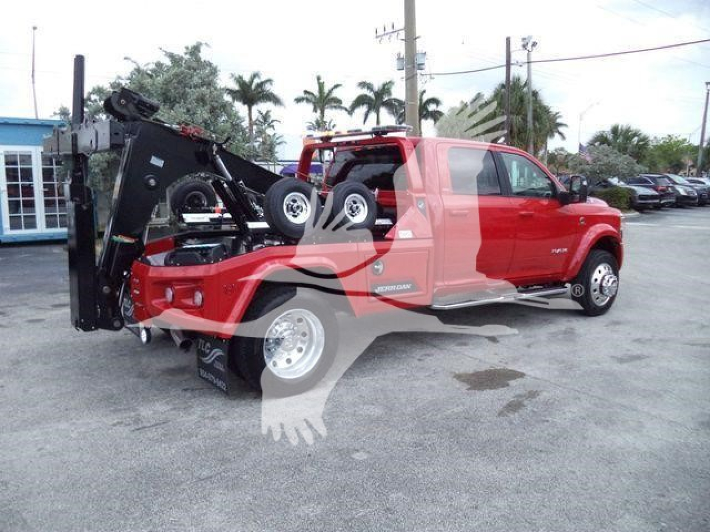 Ram 5500 pickup truck with winch, red exterior, heavy-duty bed equipment, side steps visible.