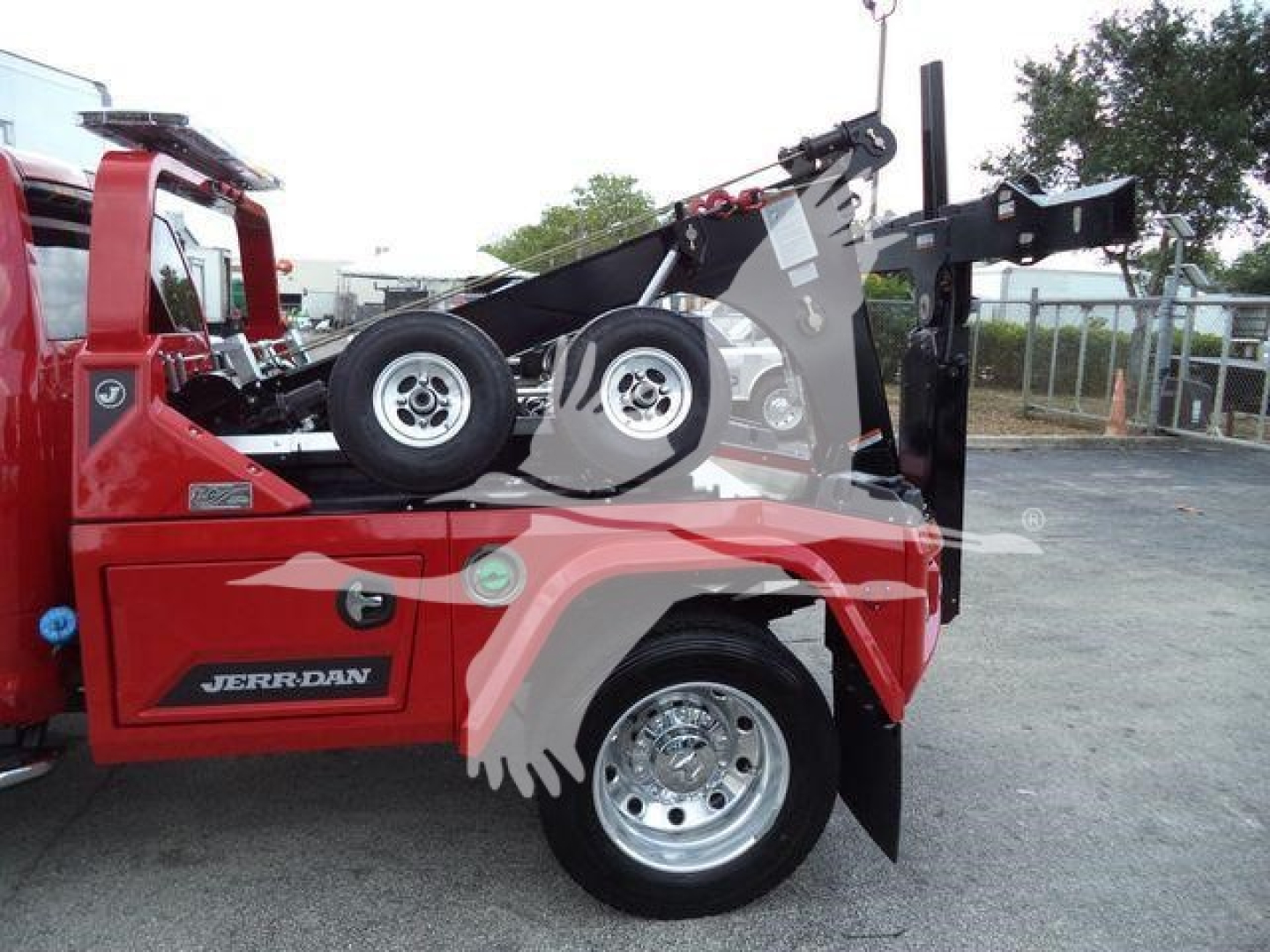 Ram 5500 dump truck with hydraulic tow winch and lifted boom side view showing wheel and front fender
