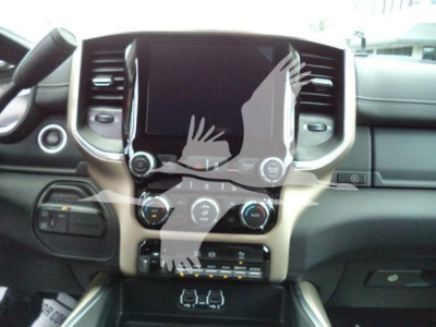 Truck interior showing center console with large touchscreen, climate controls, and stereo, Ram 5500 Laramie interior view