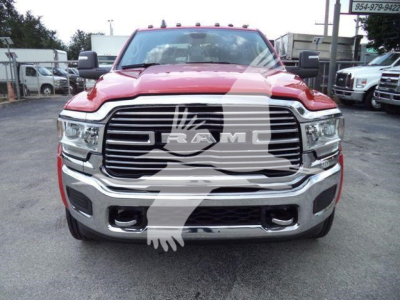 Ram 5500 truck front view showing large chrome grille with RAM emblem, red body, and bumper details.