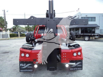 Ram 5500 w/ winch setup seen from front, two large red fenders, upper crane/mounting frame, TLC branding on license area, dealership contact numbers visible.
