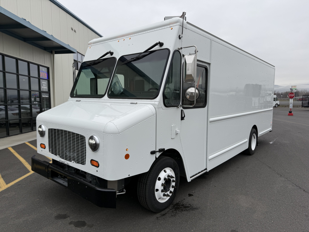 Harbinger S524 box truck in white, front three-quarter view, with cab-over design and cargo box. Clear grille, round headlights, side mirrors, and front bumper visible.
