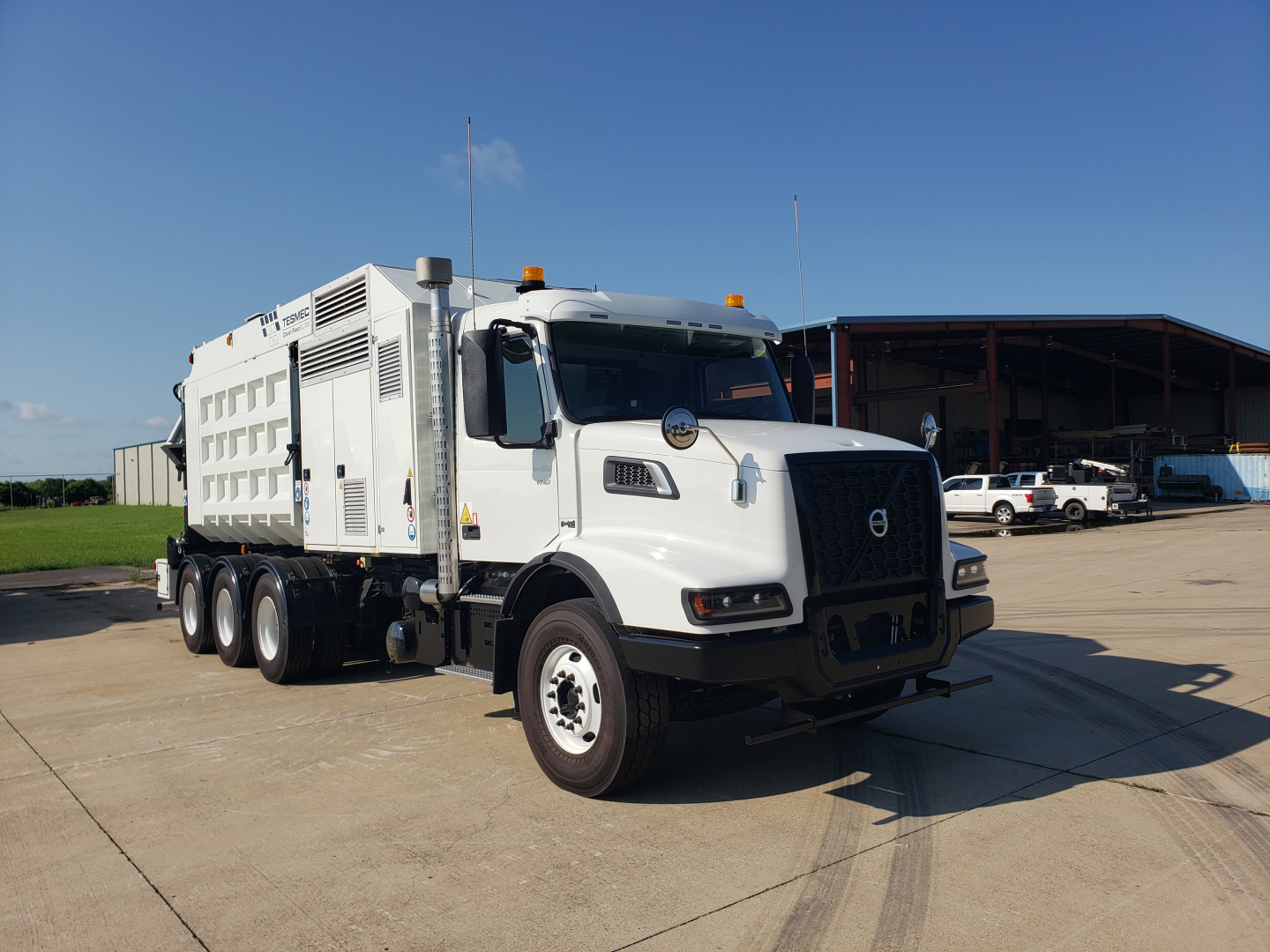 Volvo VHD86B300 trenching truck in a parking lot showing large white body and cab with Volvo emblem