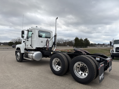 Truck chassis showing rear axles and dual wheels, with exhaust stack and fuel tank visible on the left side; no visible text on the truck components.