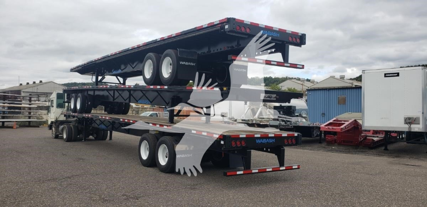 Trailer set with a raiseable flatbed and steel air slider, black with multiple axles, showing a raised upper deck and rear ramps.