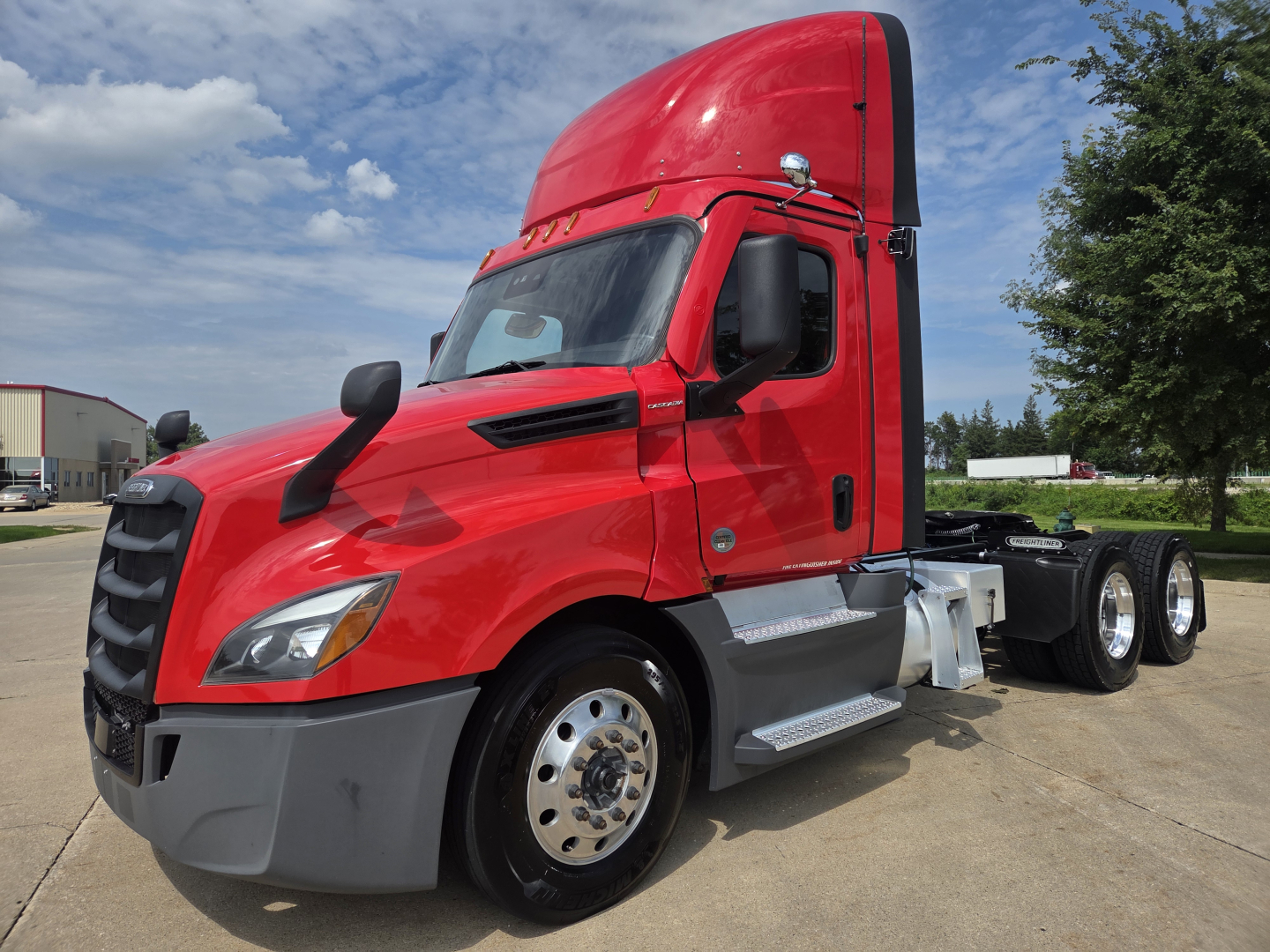 Freightliner PT126064S T sleeper cab in red, front-left view with silver steps and dual rear axles, no trailer attached.