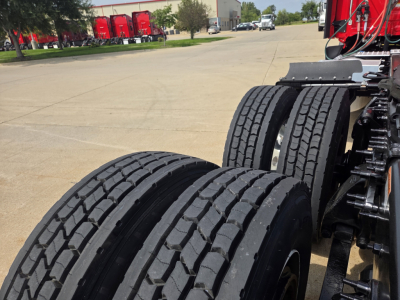 Dual rear truck axles and tires in-view; chassis and suspension components visible near wheel wells.