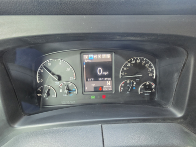 Truck instrument cluster showing digital display with 0 mph, 92°F, 117,189 miles, and various gauges in a Freightliner cab.