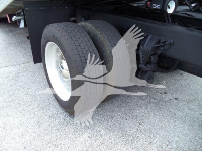 Rear dual tires and suspension on a Kenworth T270 roll-back truck showing dual rear wheels and chassis.