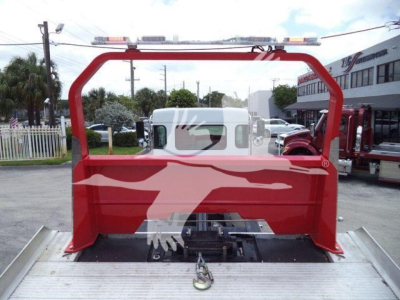 Kenworth rollback bed with red frame and silver cargo bed showing rear view and visible hitch assembly.