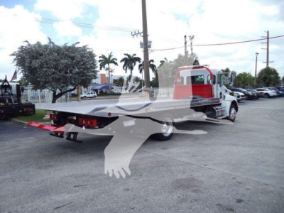 Kenworth T270 rollback tow truck with rear flatbed in view, no legible text on signs visible.