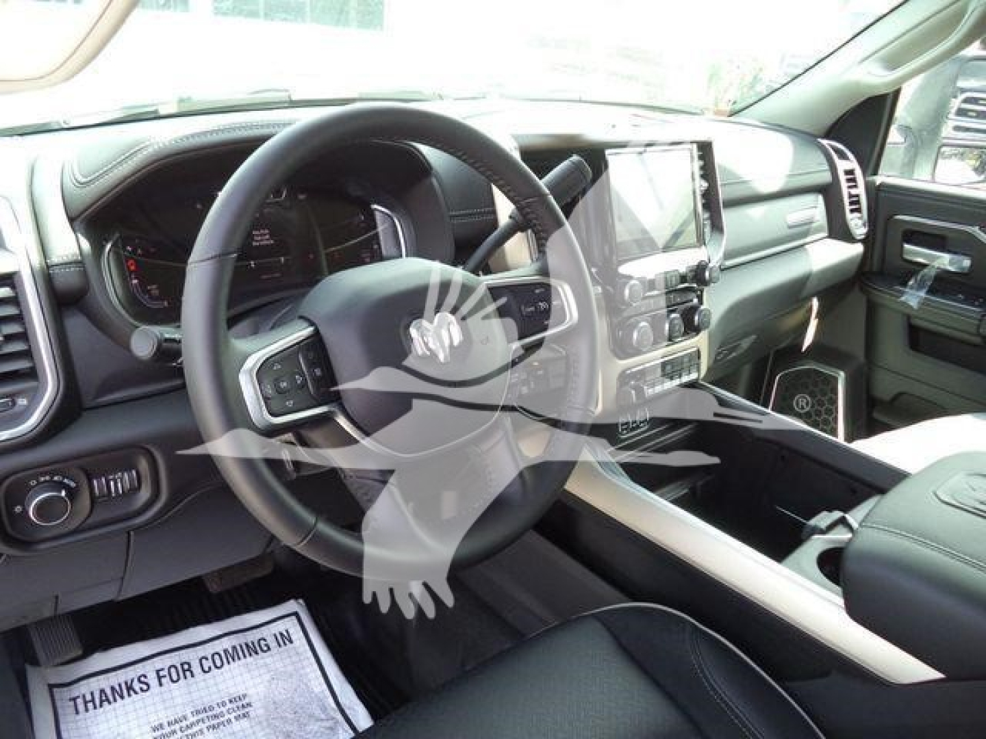 Ram 5500 interior showing steering wheel, dashboard, and center console with touchscreen display.