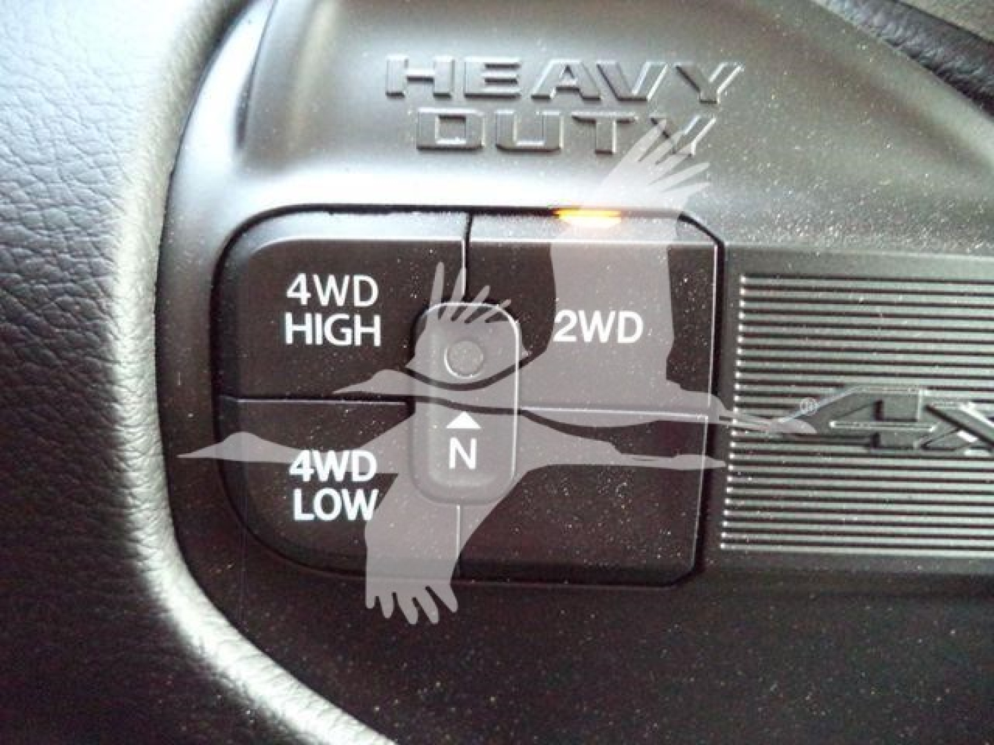 Ram 4x4 wheel selector with 4WD HIGH, 2WD, 4WD LOW buttons and a central N; label reads HEAVY DUTY above the switch.