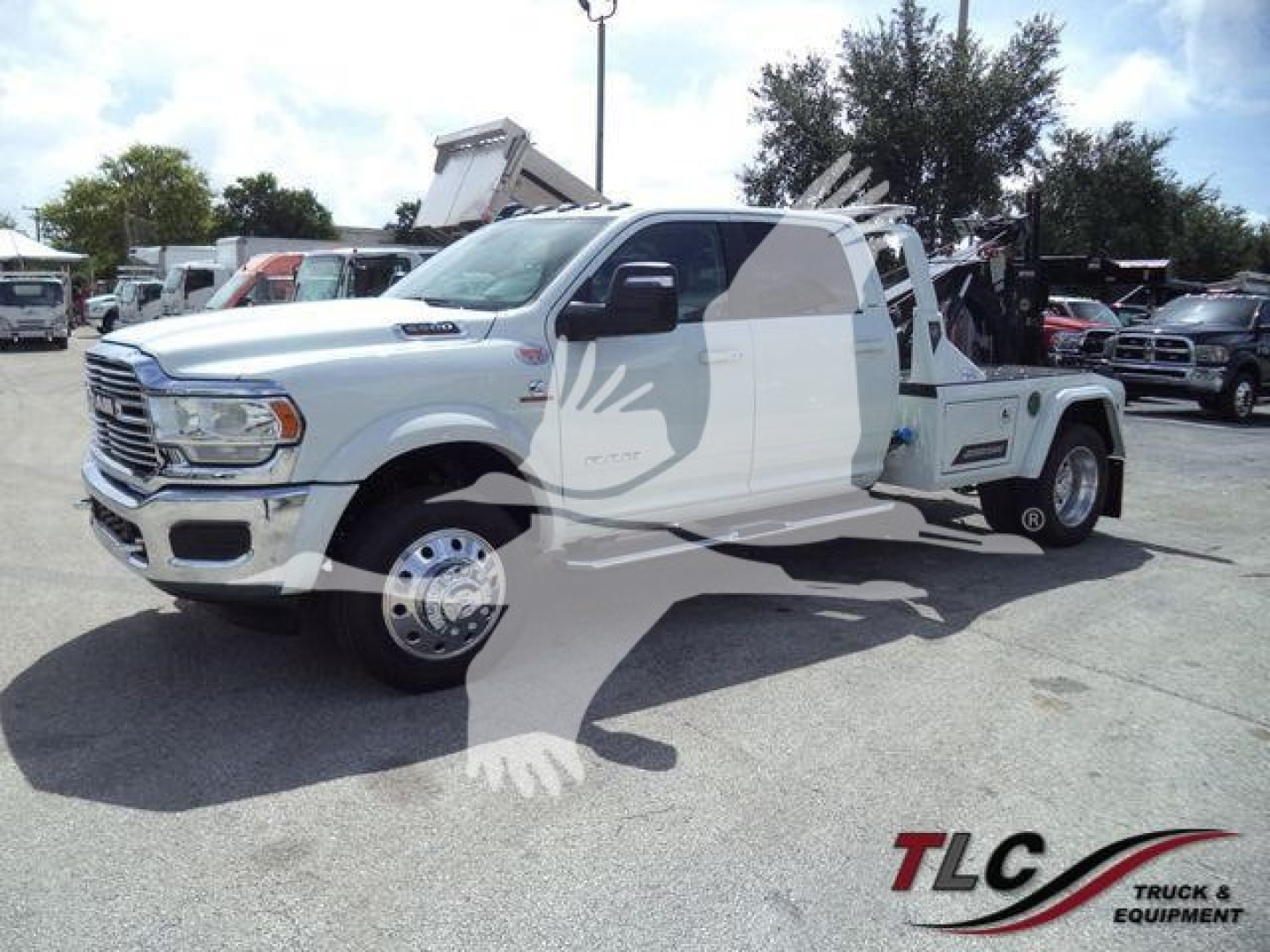 Ram 5500 truck in white with winch equipment and tow setup, side view showing cab and flatbed arrangement.