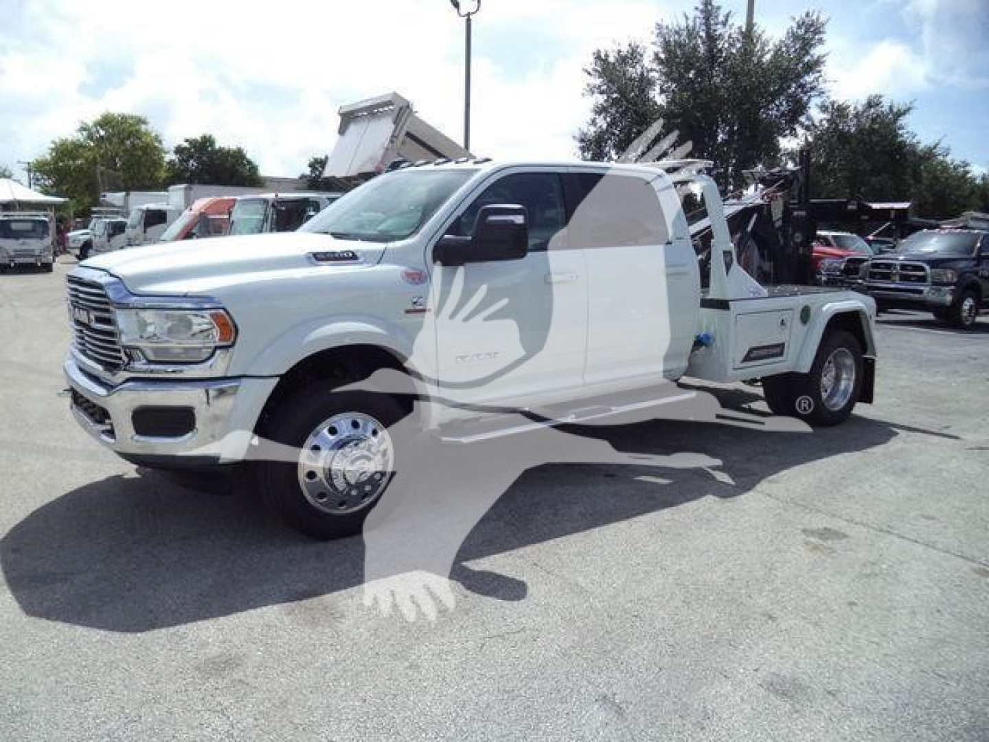 Ram 5500 tow truck/flatbed with winch setup, white exterior, side view, no text visible on components.