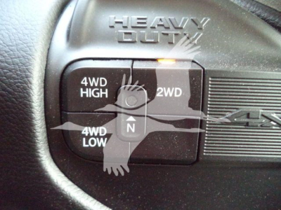 Ram 4x4 wheel selector with 4WD HIGH, 2WD, 4WD LOW buttons and a central N; label reads HEAVY DUTY above the switch.