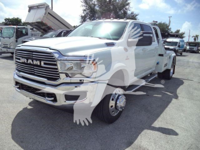 Ram 5500 Laramie truck in a dealership lot, front three-quarter view with chrome grille, dual rear wheels, and winch category context.