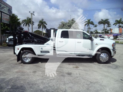 Ram 5500 Laramie pickup truck in white with a mounted winch and bed equipment, side view showing crew cab and dual rear wheels.