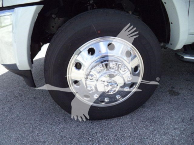 Truck wheel and chrome hubcap with tire on Ram 5500 Laramie; wheel well and fender visible