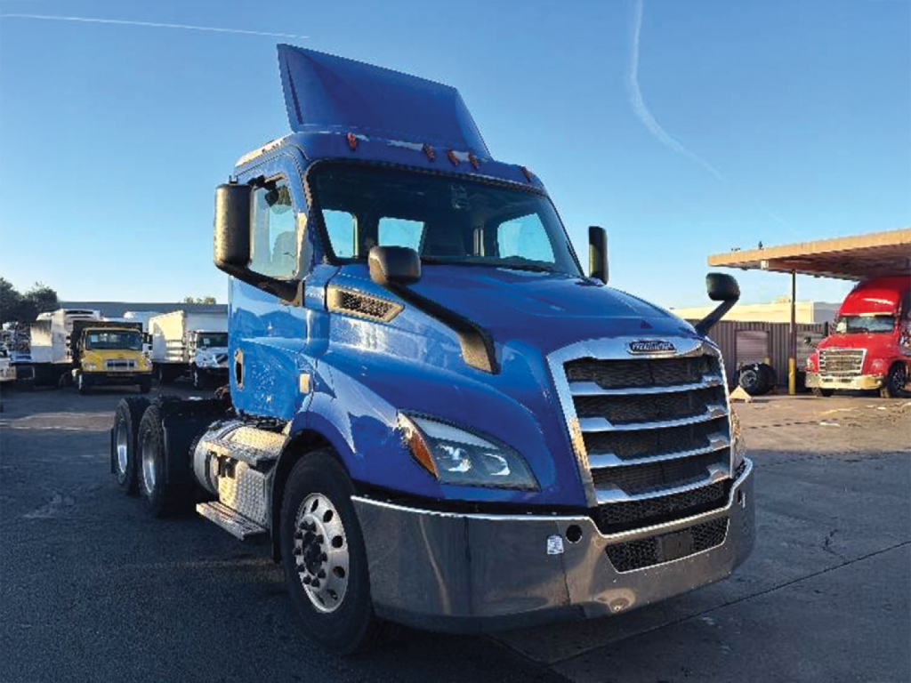 Truck cab from a blue 2019 Freightliner Cascadia 116, front-left view with chrome grille and large side mirrors.