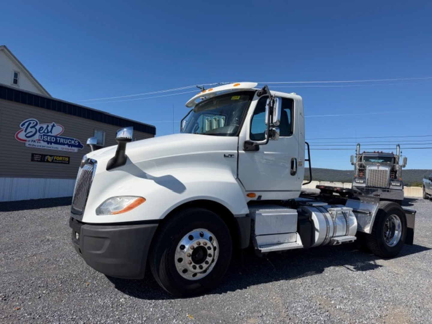 Truck cab and chassis of a 2018 International LT625 tractor in a used truck lot.