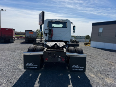 2018 International LT625 tractor rear view showing dual mud flaps with Best Trucks logo and contact numbers, chassis and wheels visible.