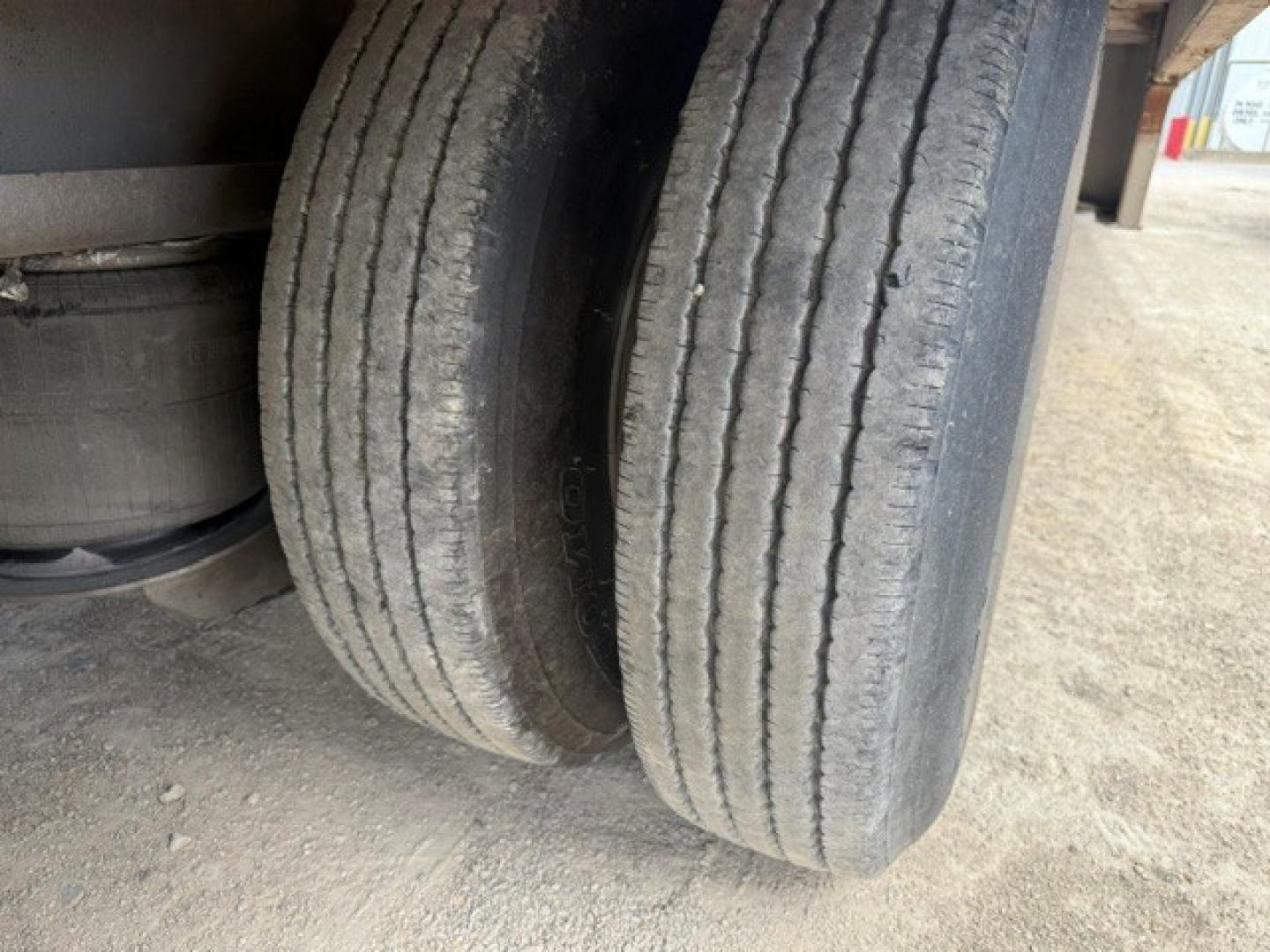 Trailer wheel area showing dual rear tires and part of the undercarriage of a 2019 Trail-Eze TE70 XTS trailer.