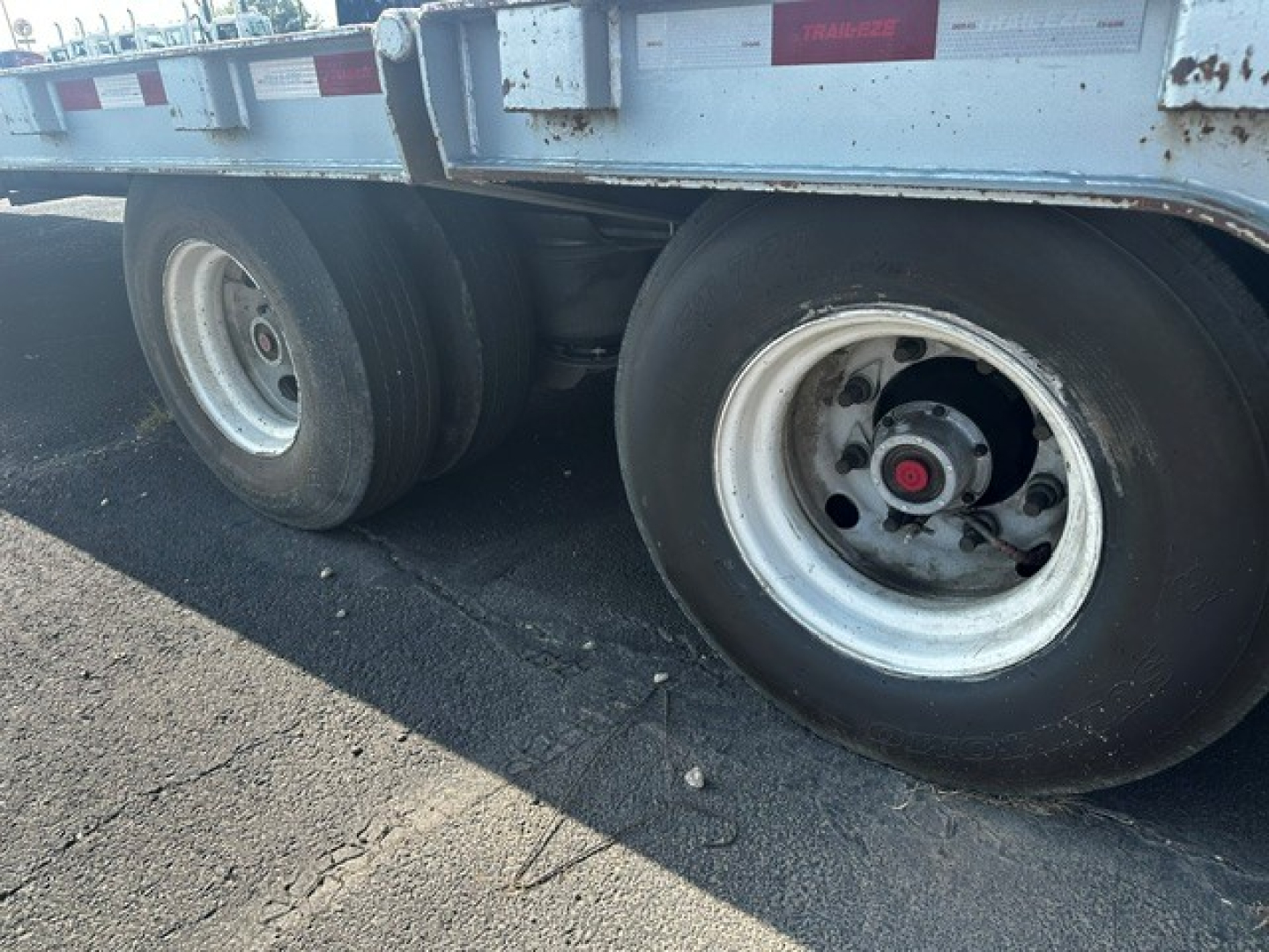 Trailer axle area showing dual rear wheels and a silver rim on a Trail-Eze TE70 XTS trailer.