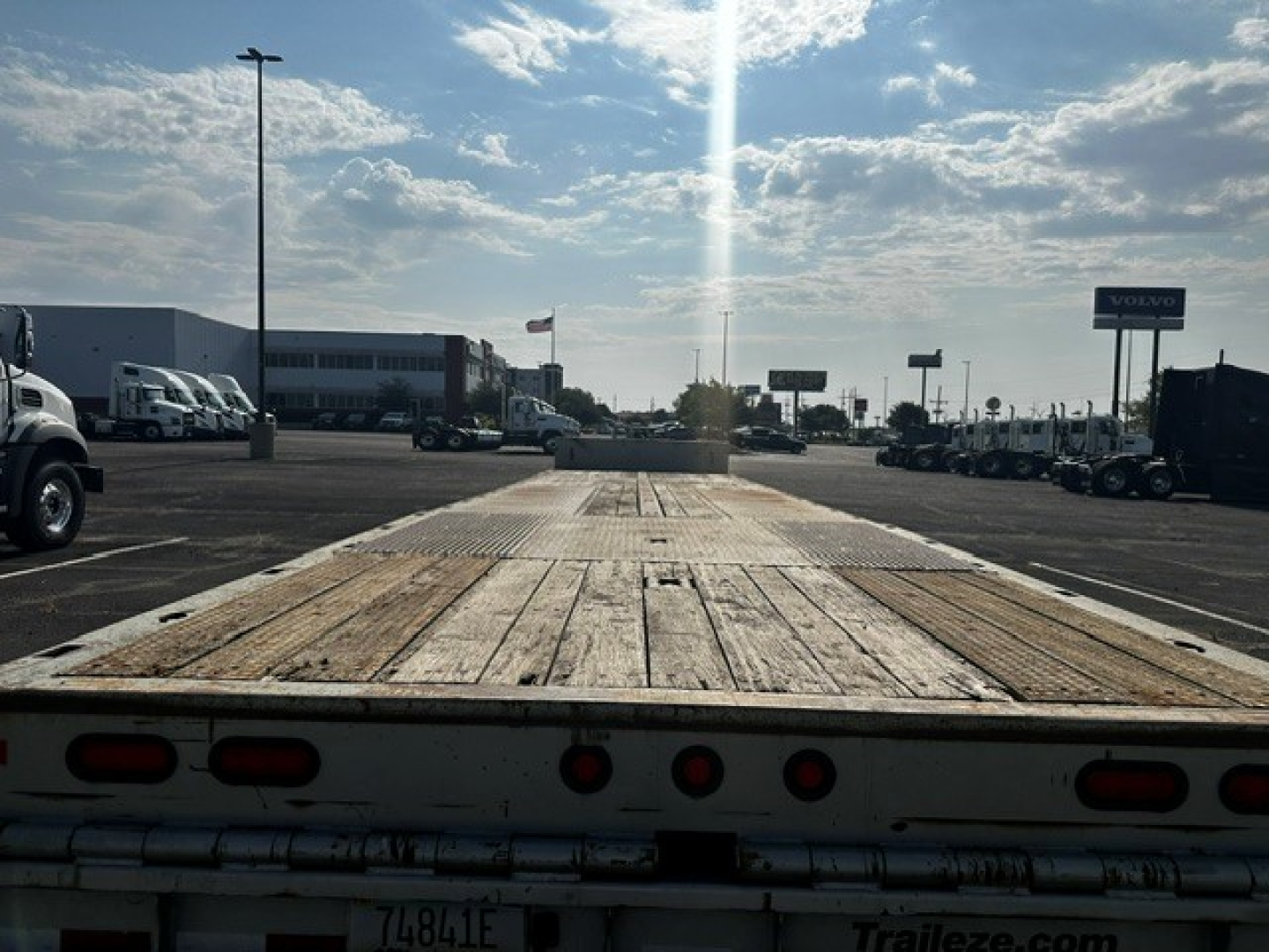 Trailer bed of a 2019 Trail-Eze TE70 XTS trailer showing wooden deck and rear lights