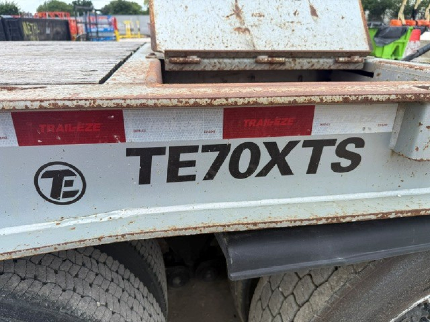 Trail-Eze TE70XTS trailer side showing TE70XTS branding and red reflective strips with Trail-Eze logos.