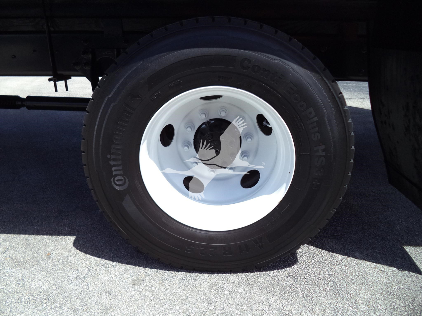 Wheel and tire on a truck showing Continental ContiTouring tire with wheel and lug nuts.