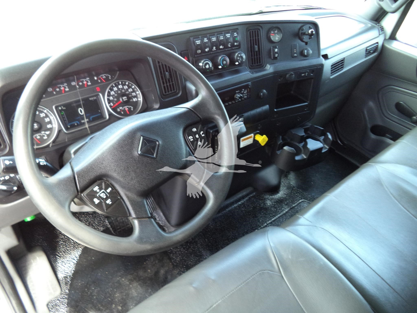Dashboard and steering wheel of a 2021 International MV truck cab interior with steering wheel, instrument cluster, and center console visible.