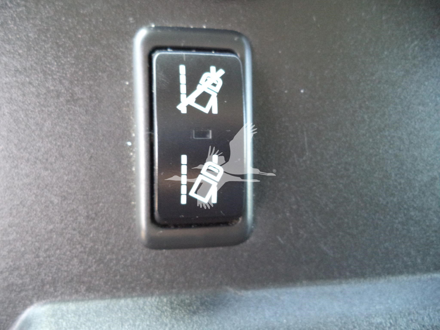 Switcher controls for seat belts in the cabin of a 2021 International MV, showing two-seat belt icons in an on/off switch.