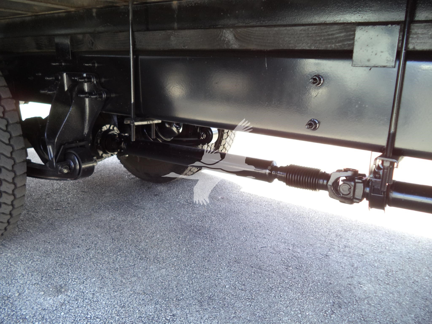 Underbody view of a 2021 International MV truck showing suspension, drivetrain, and driveline components.