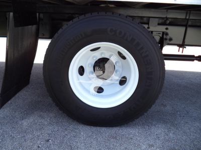 Wheel and tire of a 2021 International MV truck showing Continental tire and white steel wheel; partially visible undercarriage and frame.