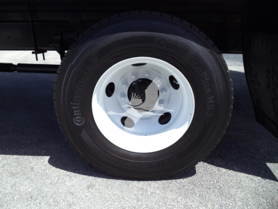 Wheel and tire on a truck showing Continental ContiTouring tire with wheel and lug nuts.