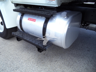 Fuel tank under International MV truck showing 'SELLER ONLY' sticker and metal steps.