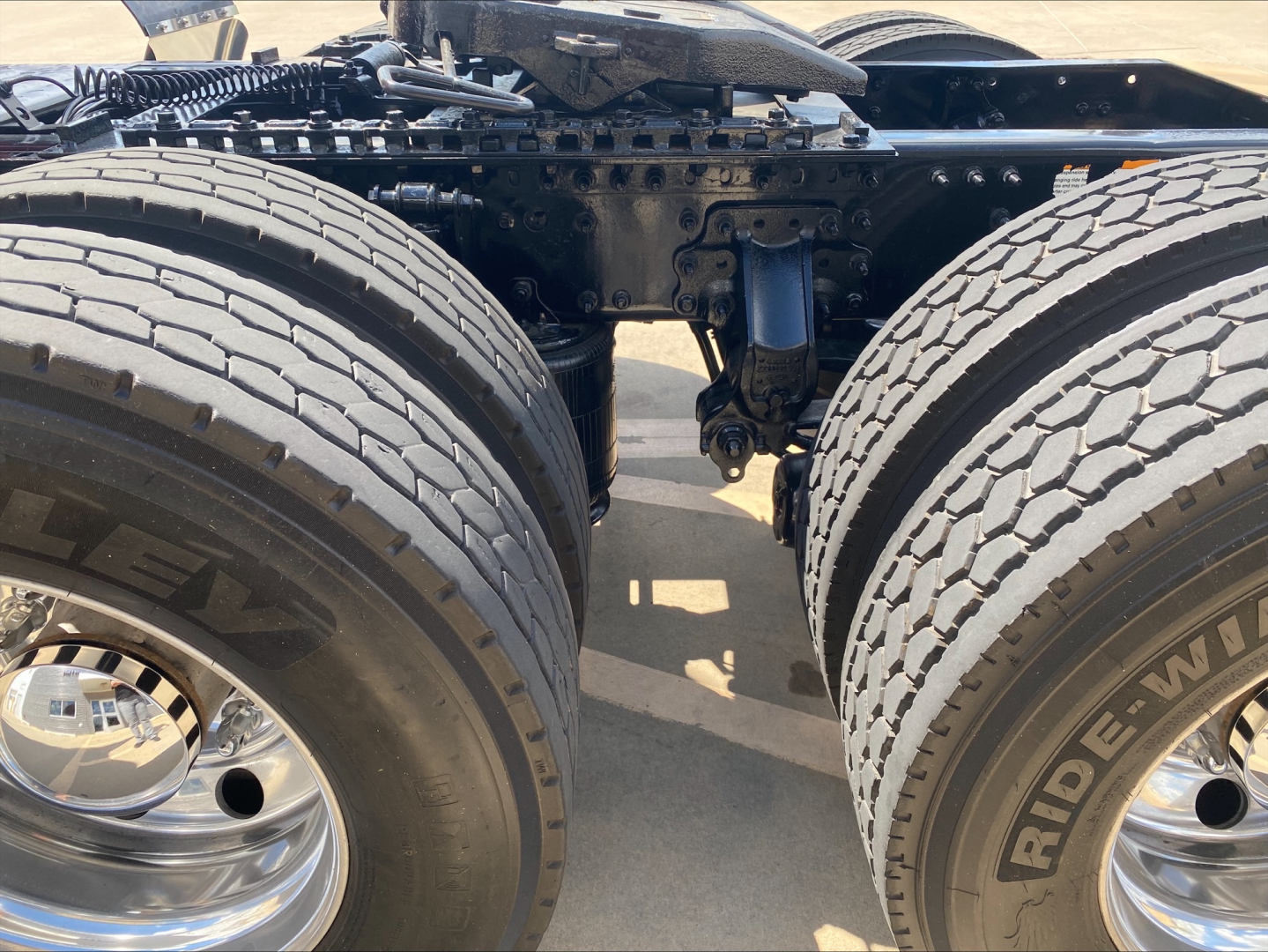 Rear view of a Mack AN64T70 tractor showing dual rear axles and suspension components.