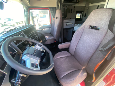 Interior of Mack AN64T70 truck cab showing steering wheel, driver seat, and dashboard with controls.