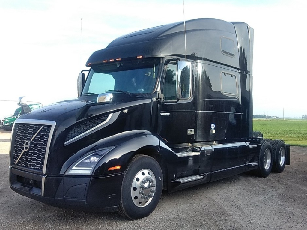 Volvo VNL64T860 sleeper cab truck in serviceable condition showing aerodynamic front with Volvo emblem, black exterior, long hood, dual rear axles, side steps and window mirrors