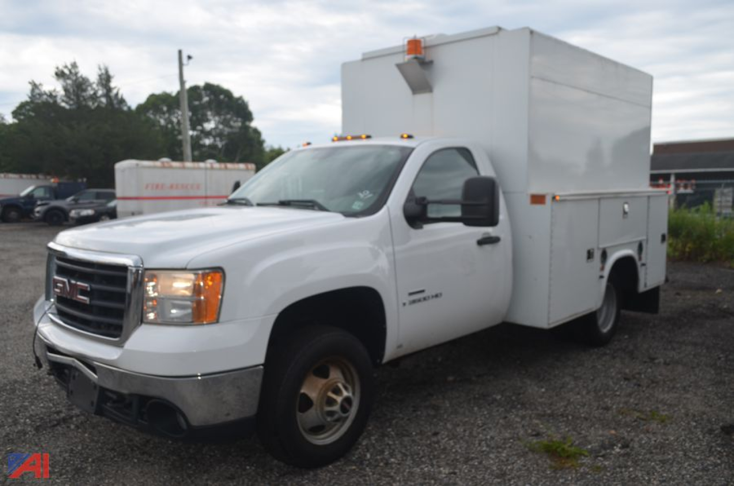 GMC Sierra 3500HD service/utility truck shown in white with utility box in bed and amber clearance lights on cab roof.